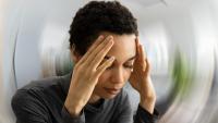 Woman holding her forehead